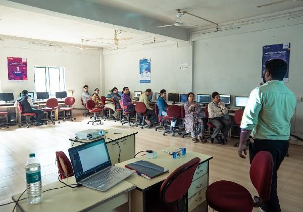 Faculty collaborating during a hands-on computer lab session